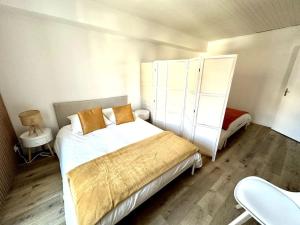 a bedroom with two beds and a chair in it at Cosy appartement centre Cusset in Cusset
