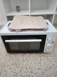 a toaster oven with a towel on top of it at Azalea garden appartment with mountain view in Kremasti