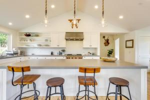 a kitchen with white cabinets and bar stools at Tranquil Santa Rosa Home with Private Pool and Views! in Santa Rosa