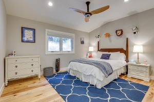 a bedroom with a bed and a blue rug at Tranquil Santa Rosa Home with Private Pool and Views! in Santa Rosa