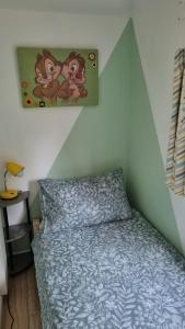 a bedroom with a bed and a painting on the wall at Turtle Lodges 29 - Riverside in Builth Wells