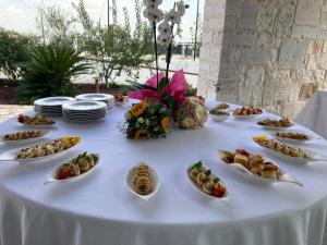 a white table with plates of food on it at Masseria Brigarè in Cassano delle Murge