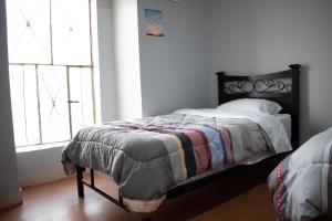 1 dormitorio con cama y ventana en Hospedaje Tel Aviv, en Ayacucho