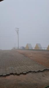 a foggy field with a pier in the background at A Chave da Montanha 