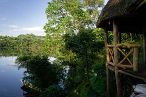 a view of a body of water with a house at Dave the Cave Eco Lodge and Cultural Campsite in Rubirizi