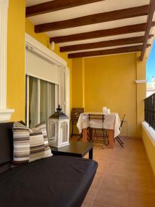 a living room with a couch and a table at Casa Amarela Guesthouse, Algorfa in Algorfa