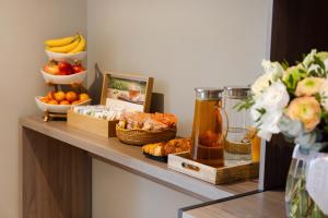 uma prateleira com um monte de comida e fruta em Mode Paris Aparthotel em Paris