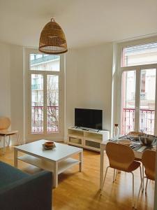 a living room with a couch and a table at 102 - Appart rénové avec grand salon et 1 chambre - Tram et Clinique Mutualiste à 1 min in Grenoble +15 photos