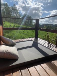 a mat on a deck with a view of a field at Tiny House no Olival in Pelotas