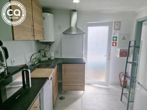 a kitchen with a sink and a counter top at Oporto House Garden in Porto