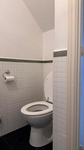 a bathroom with a white toilet in a room at Home Sweet Home (Townhouse) in Manchester