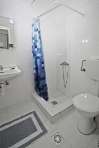 a bathroom with a shower and a toilet and a sink at Hotel Elena in Pyrgadikia