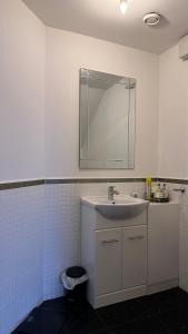 a bathroom with a sink and a mirror at Home Sweet Home (Townhouse) in Manchester