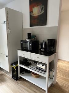 a white cabinet with a microwave on top of it at Viva la Wildbad in Bad Wildbad