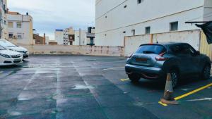 a parking lot with a car parked in it at CASA ALTA LOFT in Málaga