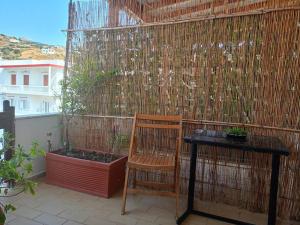 a wooden chair and a table on a balcony at katerina's house in Khónai