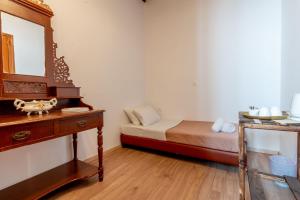 a bedroom with a bed and a dresser and a mirror at Mascot Memories in Rhodes Town