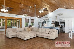 a living room with a couch and a kitchen at Riverwood Lodge in Foley