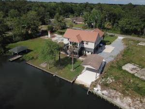 an aerial view of a house by the water at Riverwood Lodge in Foley