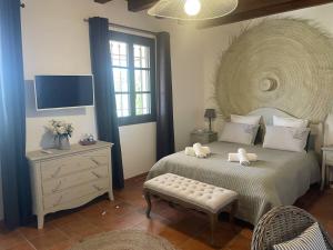 a bedroom with a large bed and a television at Appartement Murs, 8 pièces, 10 personnes - FR-1-767-17 in Murs