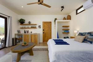 a bedroom with a large bed and a table at Mantra Baja, Boutique Hotel in Los Barriles