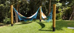 a group of hammocks hanging from poles in a park at Conforto e Privacidade no Roteiro do Vinho in São Roque