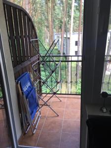 a room with a balcony with a chair on a porch at Apartament w Łukęcinie BlueMare in Łukęcin