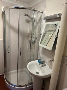 a bathroom with a shower and a sink at The Kinross Salutation Hotel in Kinross