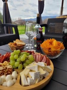 a table with a plate of cheese and other foods at Apartament BESKIDLOVE in Węgierska Górka