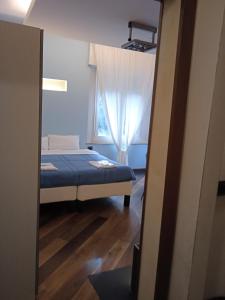 a bedroom with a bed and a window at Maison Saragozza in Bologna +4 photos