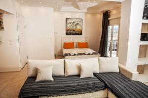 two beds with white pillows in a room at Seafront central Apt in Lavrio in Lávrion