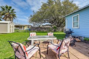 a patio with a table and four chairs at Cozy Texas Cottage Less Than 2 Mi to Rockport Beach! in Rockport
