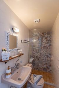a bathroom with a sink and a toilet and a shower at mascot traditional guest house in Rhodes Town