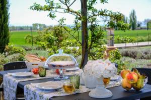 a table with plates and bowls of fruit on it at Il Fienile di Assisi in Assisi