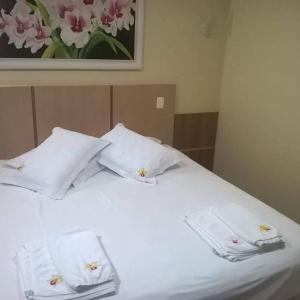 Кровать или кровати в номере Pousada Paraíso das Orquídeas