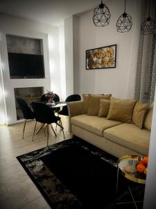 a living room with a couch and a table at Apartament Nowar in Nowa Ruda