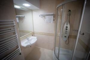 a bathroom with a shower and a sink at Hotel Górski in Wolbórz
