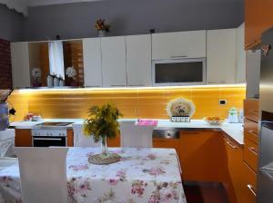 a kitchen with a table with a vase on it at Sunny villa Borakaj Vlora in Vlorë
