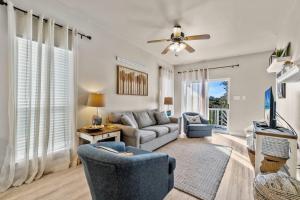 a living room with a couch and a tv at Big Blue Cottage 2A in Gulf Shores