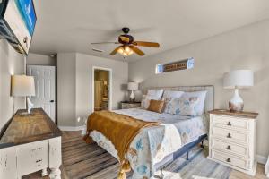 a bedroom with a bed and a ceiling fan at Big Blue Cottage 2A in Gulf Shores