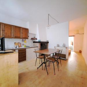 a kitchen with a table and chairs in a room at Loft antico La casina di Paola in Seggiano