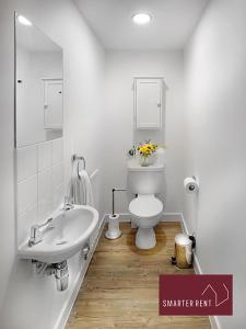a white bathroom with a sink and a toilet at Jennett's Park, Bracknell - 2 Bedroom Home in Bracknell