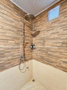 a bathroom with a shower with a glass wall at Keveli Guesthouse in Himmafushi +66 photos