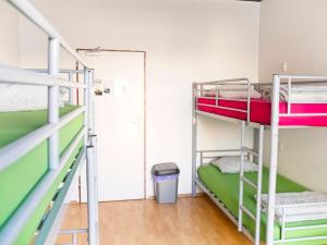 a room with two bunk beds and a door at Urban Elephants Hostel in Bratislava