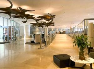 eine große Lobby mit einem Dinosaurier an der Decke in der Unterkunft Hotel Nacional rj in Rio de Janeiro
