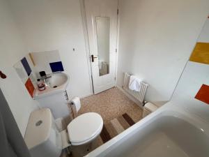 a small bathroom with a toilet and a sink at Cosy 2 bedroomed semi detached house in Brettell Lane