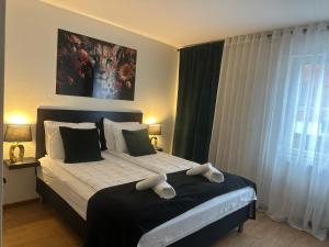 a bedroom with a bed with two stuffed animals on it at Hotell City Karlshamn in Karlshamn