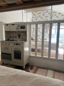uma cozinha com um fogão e uma janela num quarto em Un été sans fin em Lauris