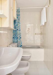 a white bathroom with a toilet and a sink at La Solanda de Sallent in Sallent de Gállego +26 photos