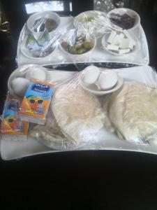 two trays of food with eggs and other foods at white tulips studio in Jerash